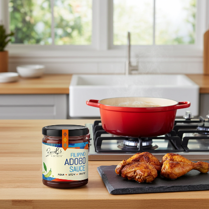 Bottle of RoniBs Kitchen Filipino Style Adobo Sauce in a kitchen setting, showing rich, dark condiment used in Philippine cuisine.