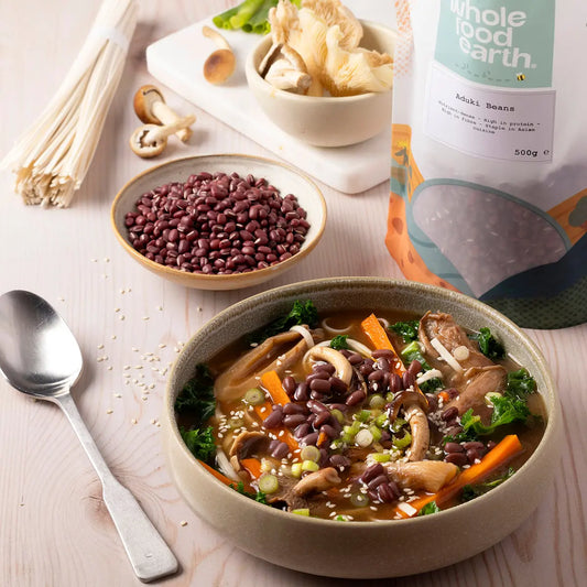 Whole Food Earth aduki beans in a bowl with fresh vegetables, showcasing healthy beans and pulses for nutritious meals.