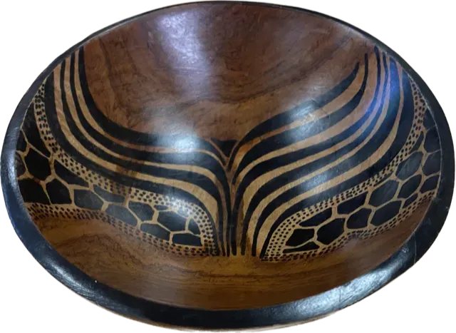 Hand-carved African wooden bowl from Goch & Co, showcasing intricate designs and a smooth, polished surface for elegant cultural décor.