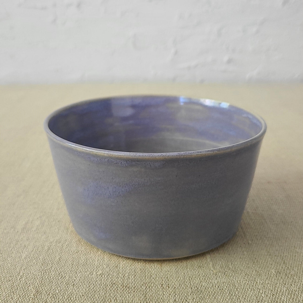 Amethyst purple ceramic breakfast bowl by Katie L Thompson Designs, featuring a smooth, rounded shape and glossy finish.