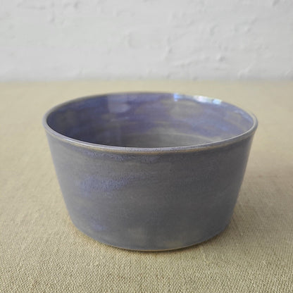 Amethyst purple ceramic breakfast bowl by Katie L Thompson Designs, featuring a smooth, rounded shape and glossy finish.