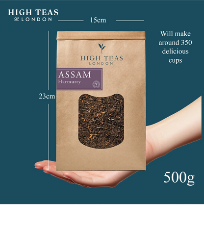 Handful of Assam Hunwal 2nd flush TGFOP1 tea leaves from High Teas, showcasing ripe, twisted leaves with golden tips.