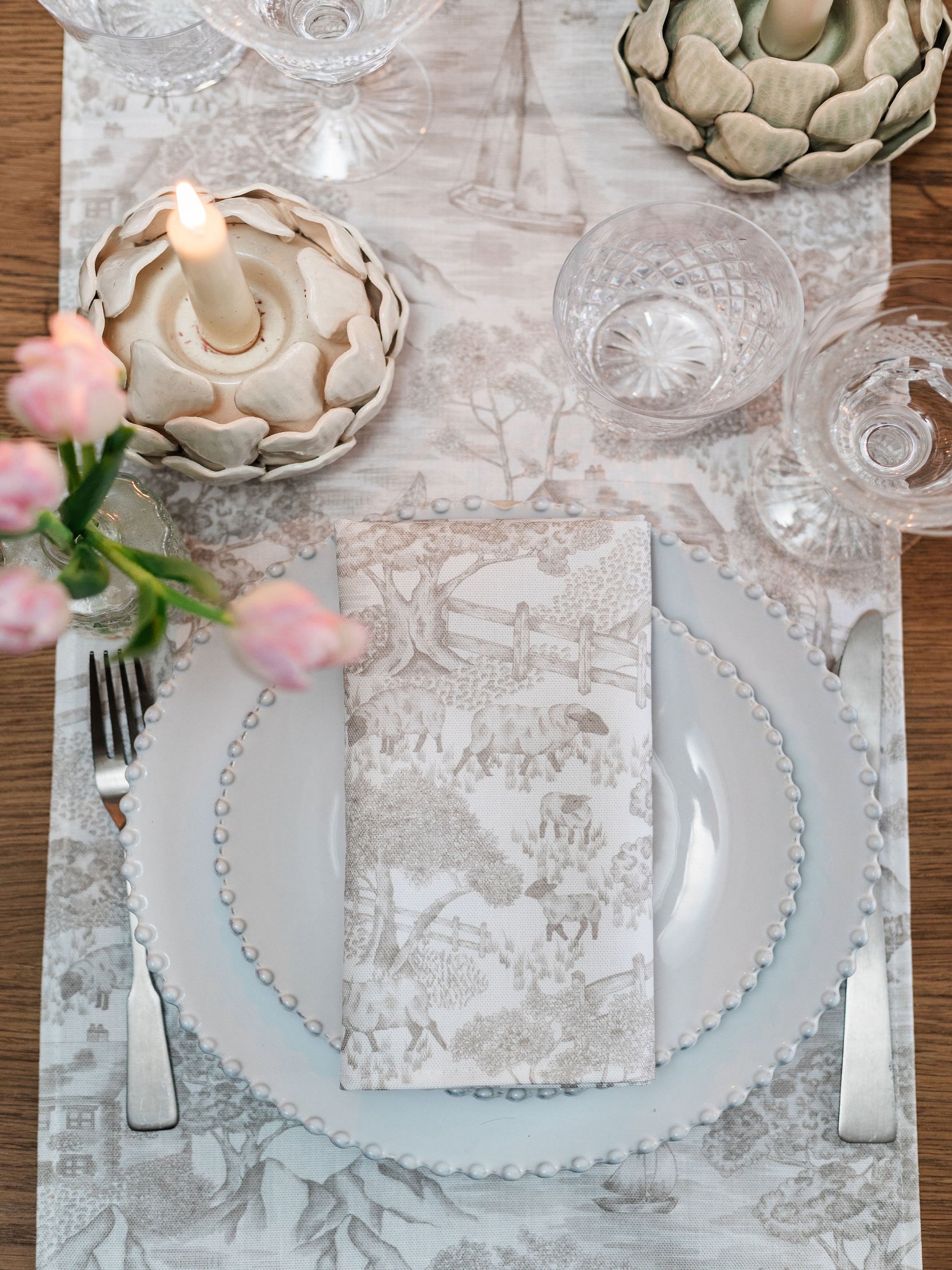 Pair of soft Avalon Home UK toile napkins with a floral spring and summer pattern, perfect for elegant table settings.