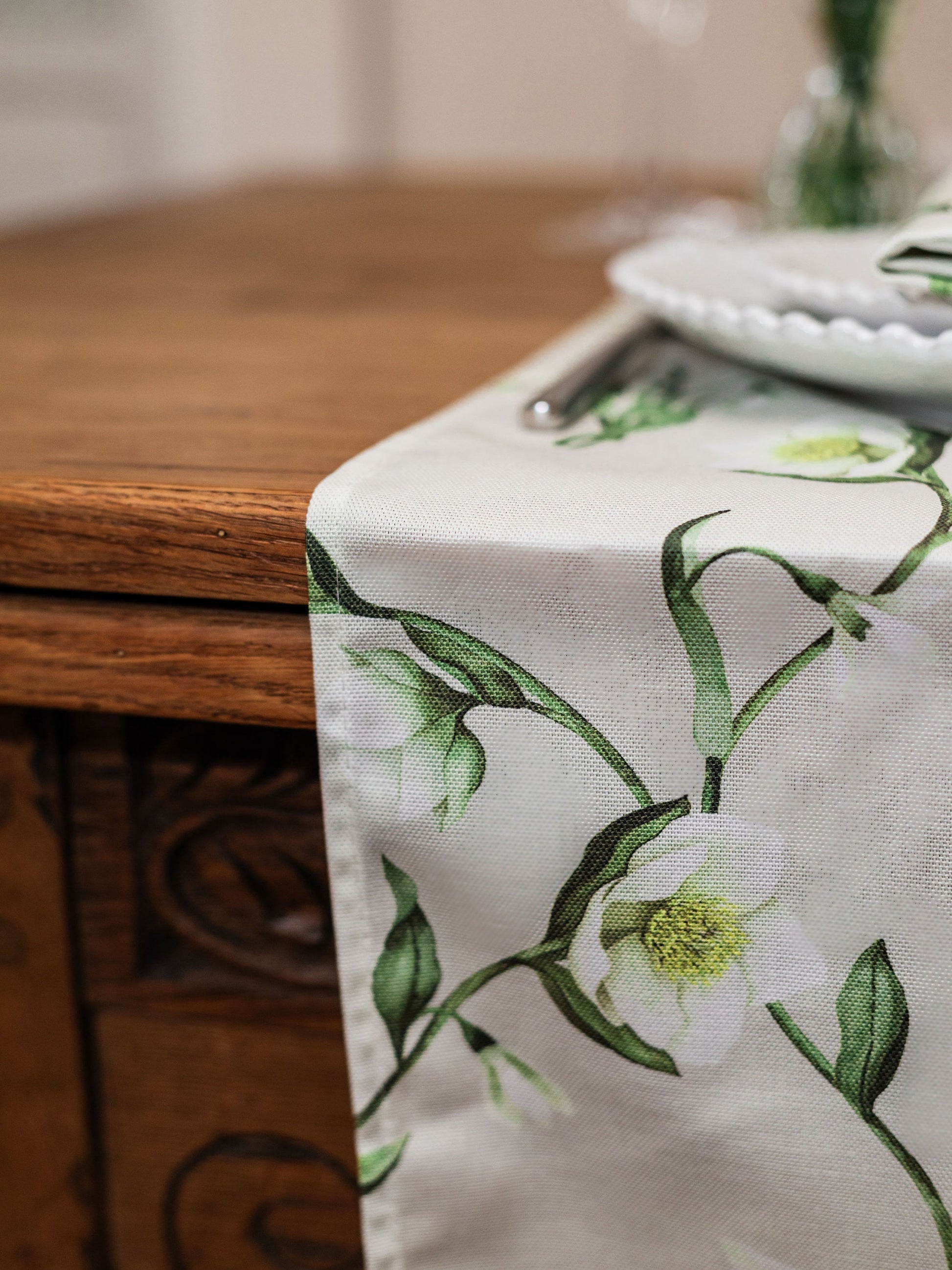 Snowdrop and hellebore floral table runner from Avalon Home UK, shown on a spring table setting with fresh greenery.