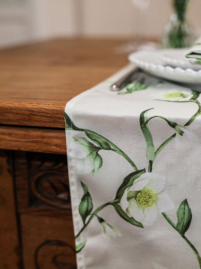 Snowdrop and hellebore floral table runner from Avalon Home UK, shown on a spring table setting with fresh greenery.