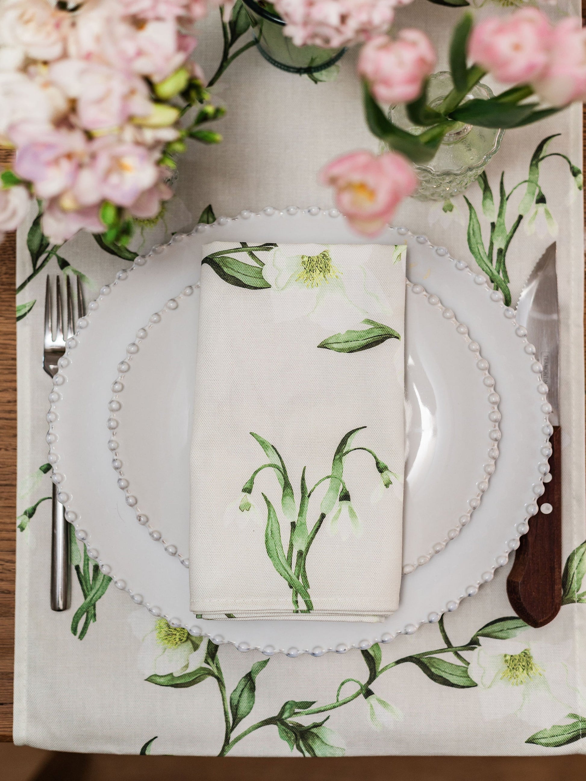 Pair of Avalon Home UK snowdrop and hellebore floral napkins with elegant spring and summer botanical designs.