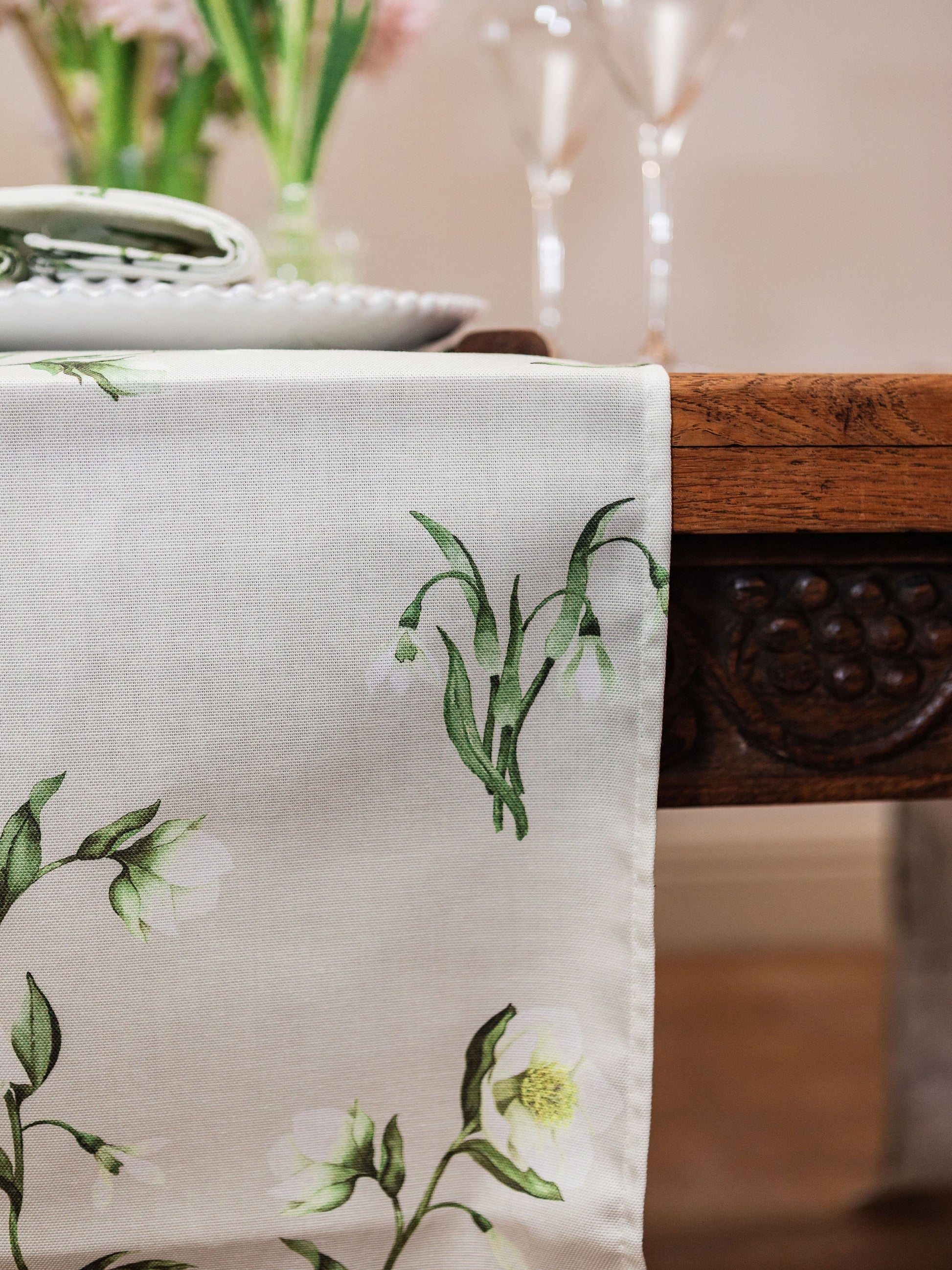 Elegant table runner featuring snowdrop and hellebore floral patterns by Avalon Home UK for spring and summer decor.