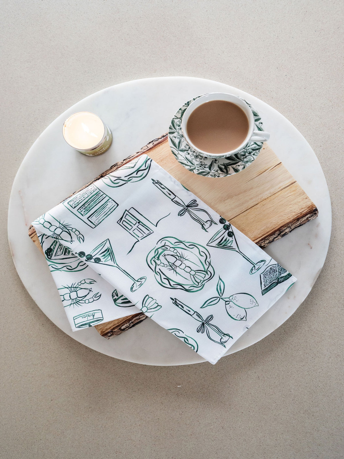 Close-up of Avalon Home UK "Just A Girl" tea towel featuring spring and summer floral patterns displayed on a kitchen countertop.