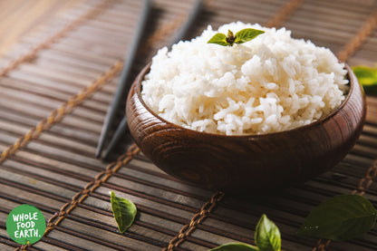 Whole Food Earth jasmine rice in a clear bag, showcasing long, fragrant grains of rice and couscous on a white background.