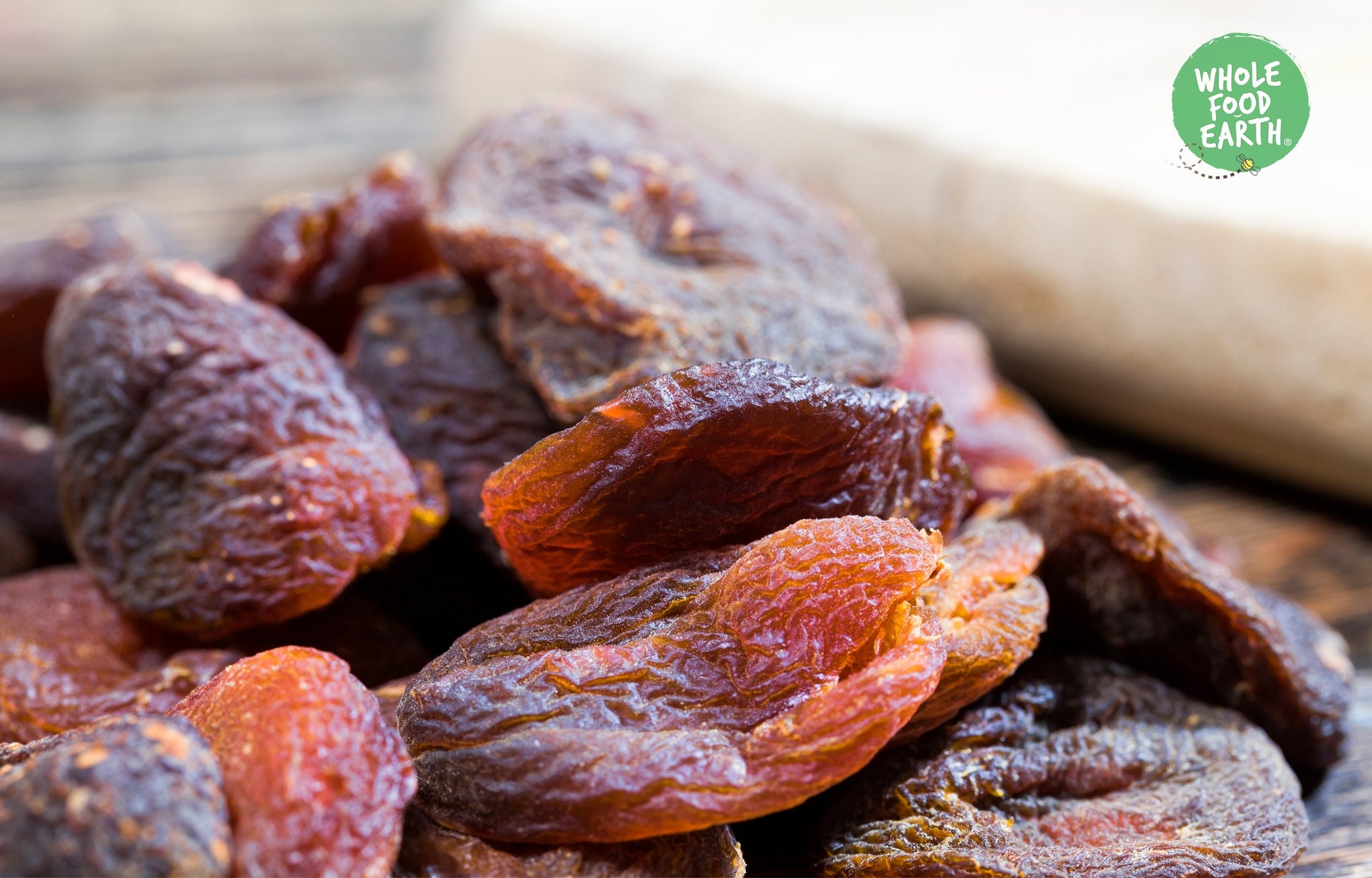 Dried whole apricots from Whole Food Earth, natural and plump, with a vibrant orange color, arranged in a bowl for snacking or baking.