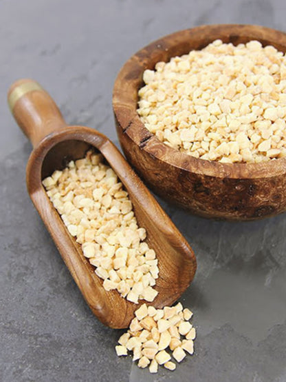 Whole Food Earth nibbed almonds, crunchy nuts and seeds, close-up of roasted almond pieces with textured surface and natural brown color.