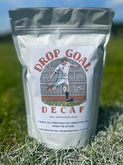 Decaf Drop Goal Coffee by Clubhouse Roastery featuring a bag of decaffeinated coffee beans with a modern label design.