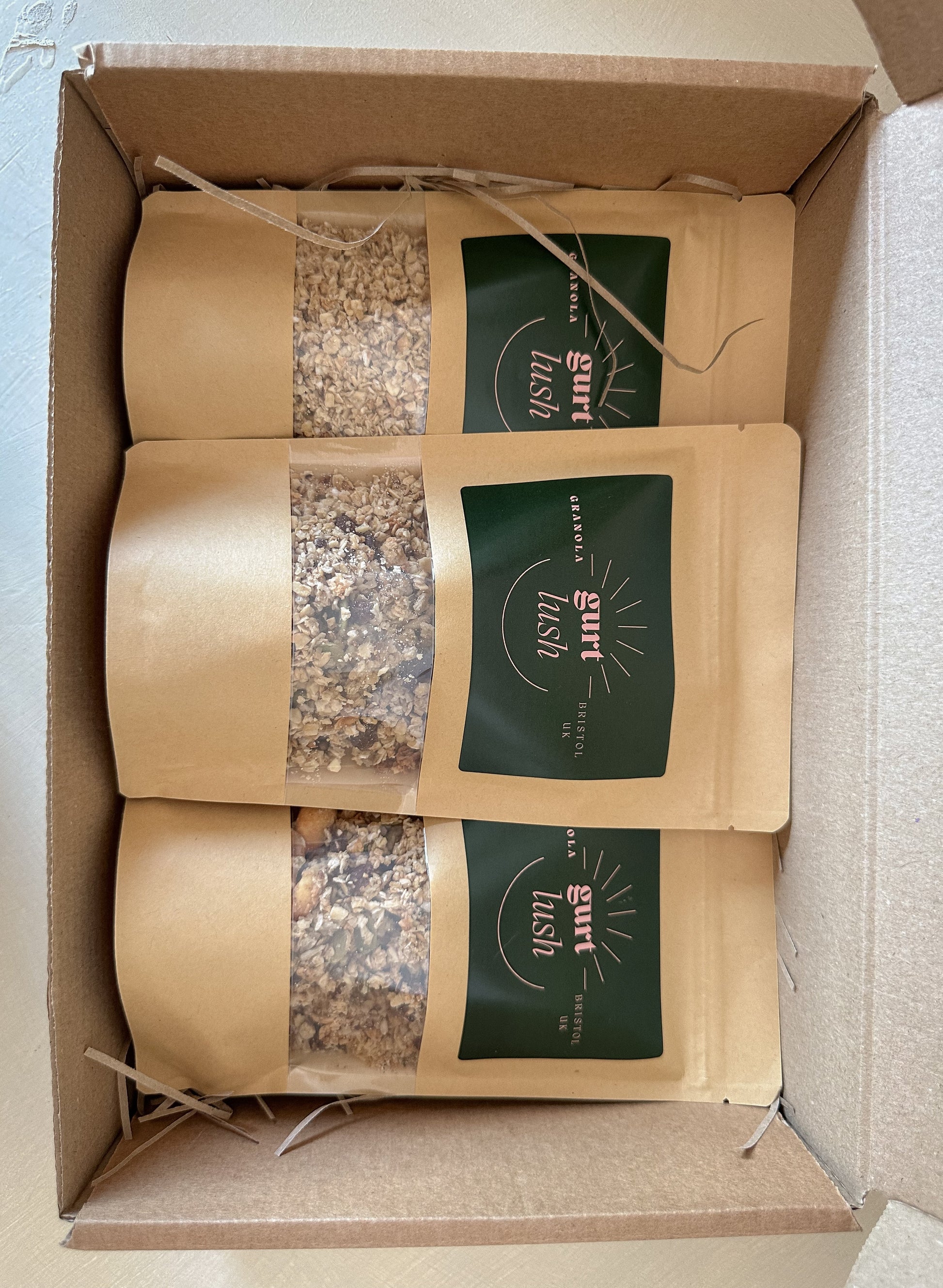 Gurt Lush Food Co granola taster box featuring a variety of flavorful granola samples in clear packaging.
