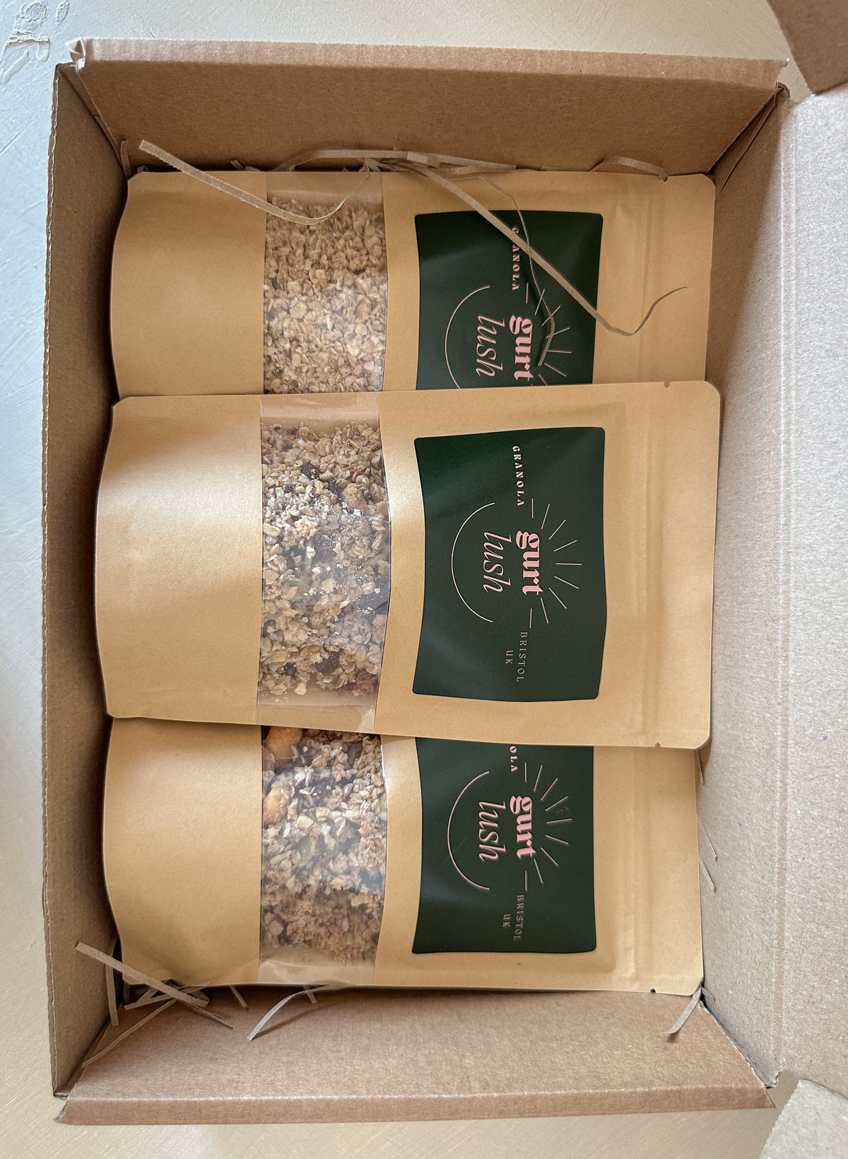 Gurt Lush Food Co granola taster box with assorted granola flavors in a colorful box, perfect for sampling breakfast options.