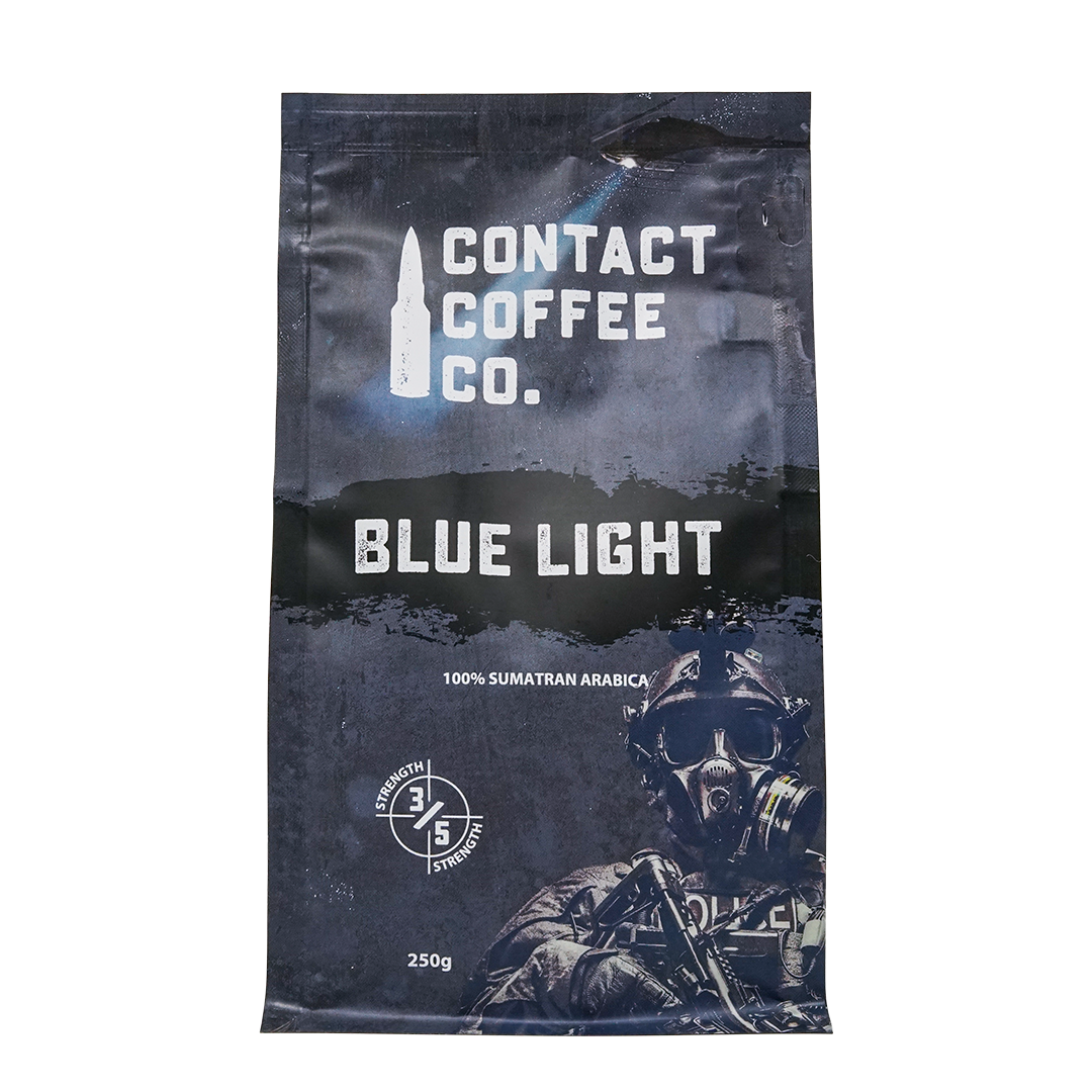 Blue Light Coffee by Contact Coffee Company Ltd., a steaming cup of coffee with a blue light logo on a rustic wooden table.