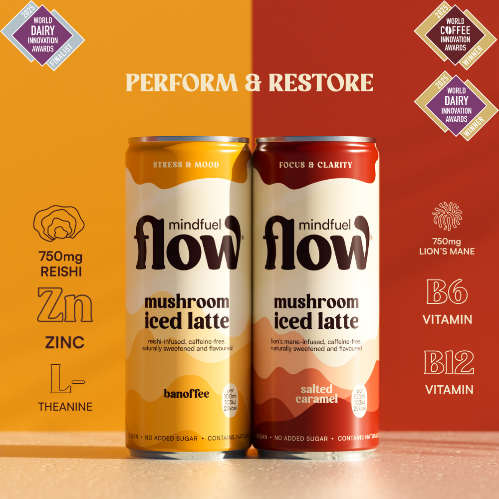 Mindfuel Flow Lion's Mane and Reishi oat latte mix in a jar with a spoon on a wooden surface.