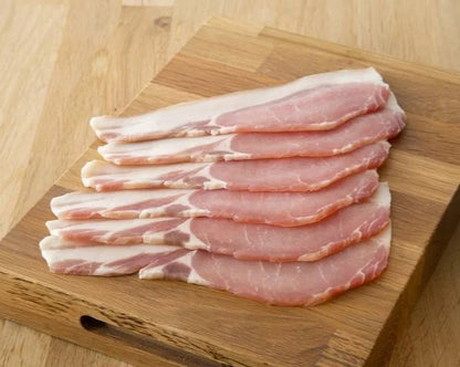 Thin slices of dry cured back bacon from Primrose Herd, showcasing marbled meat with a lean, pink appearance and crispy edges.