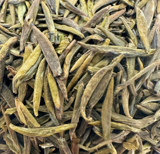 Porter Hill Tea Company's Badaling Yellow Green Tea leaves in a clear glass jar with a green label.