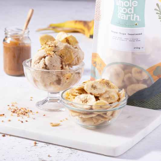 Sweetened banana chips from Whole Food Earth, dried fruit snack with crispy, golden banana slices on a rustic plate.