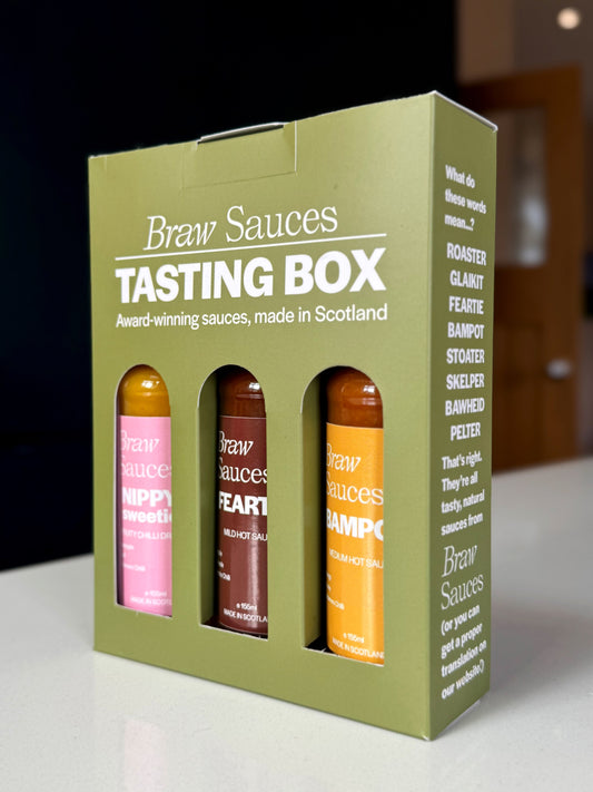 Braw Sauces barbecue tasting box gift set with assorted barbecue sauces and condiments in a decorative box.