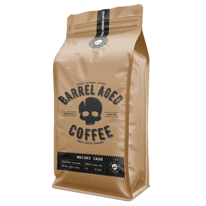 Barrel Aged Skull Crusher Coffee in a bag with a skull logo, showcasing rich coffee beans and packaging details.