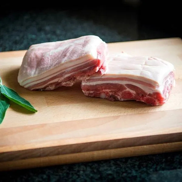 Primrose Herd pork belly squares showing crispy, golden-brown pork belly pieces on a white background