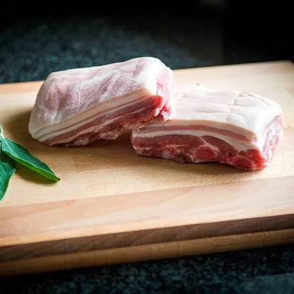 Primrose Herd pork belly squares showing crispy, golden-brown pork belly pieces on a white background