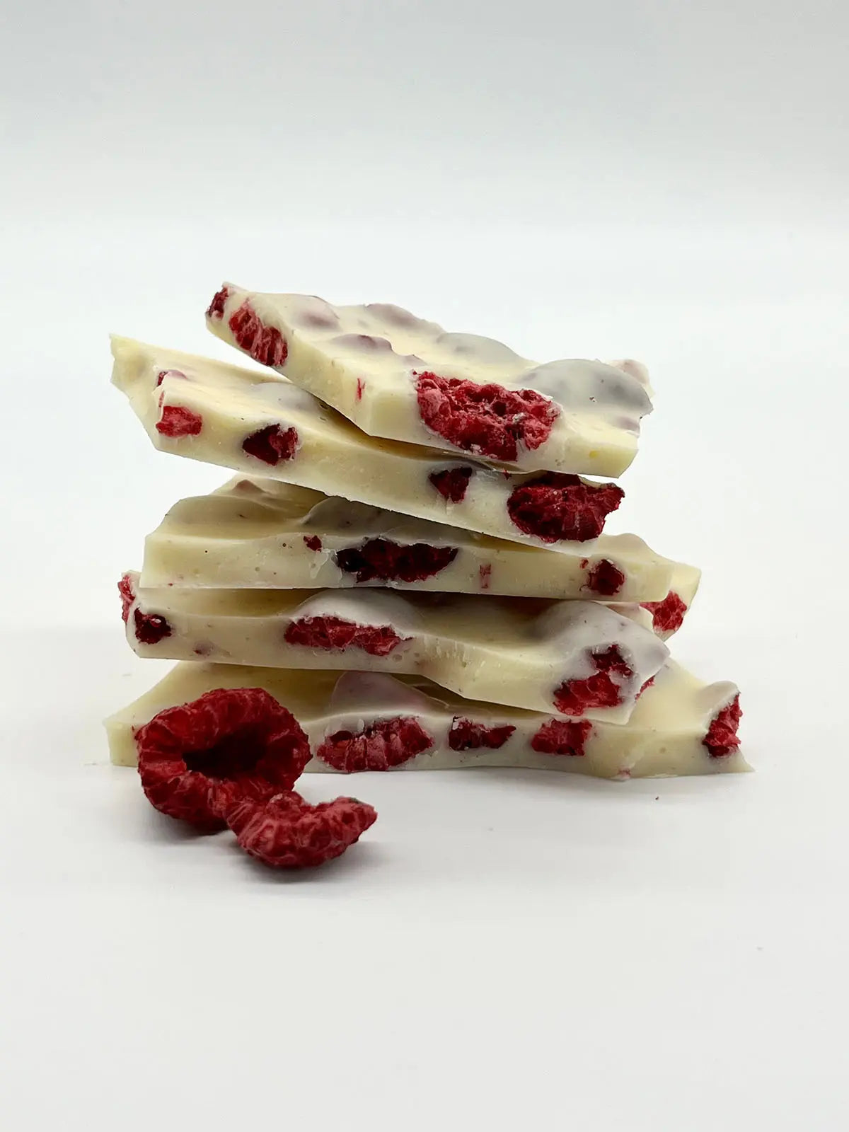 Handmade white chocolate and raspberry berry delicious dessert stack by Gorvett & Stone, featuring fresh berries and chocolate layers.