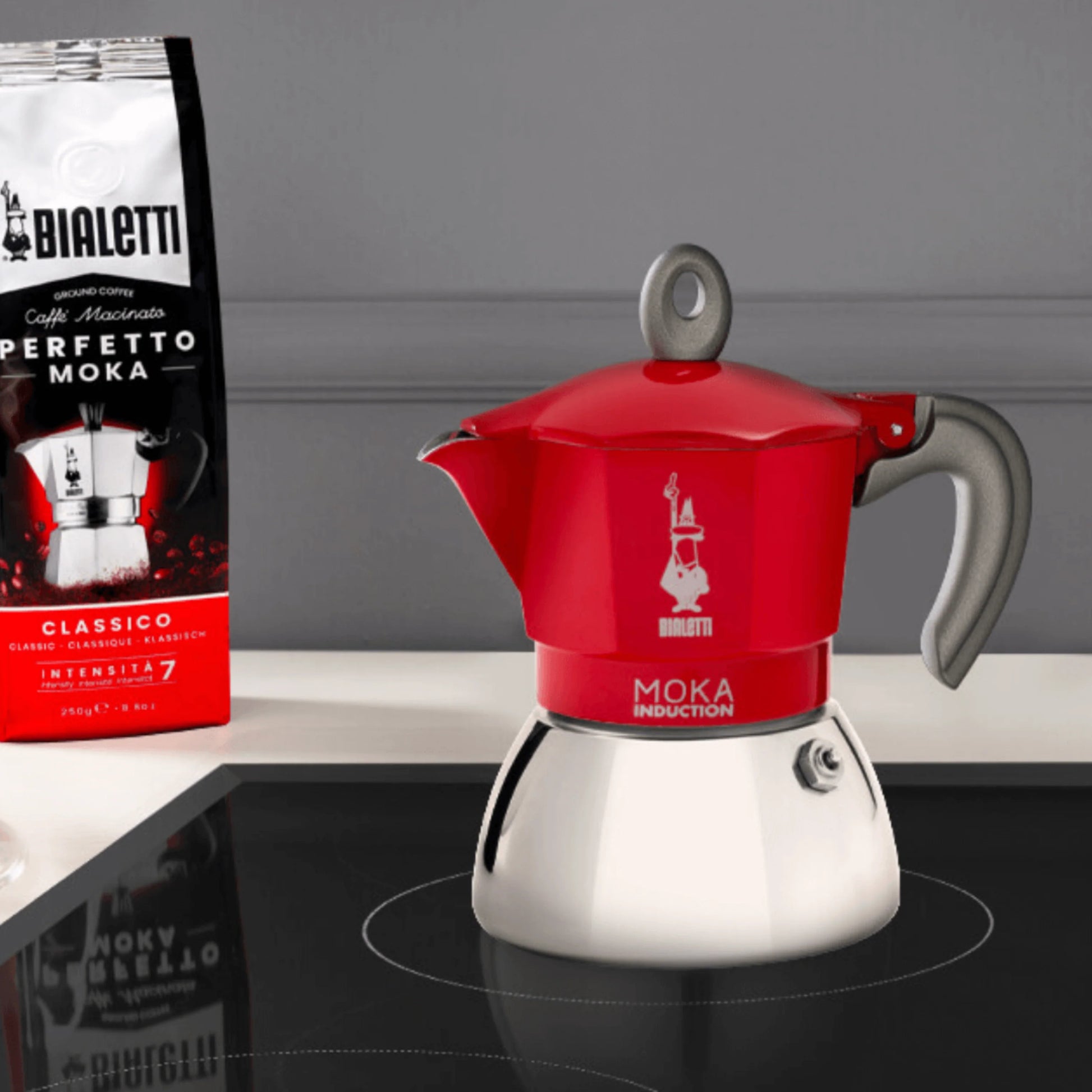 Red Bialetti Moka Induction stovetop coffee maker by Brew Italia, with a sleek design and sturdy hardware for brewing espresso.