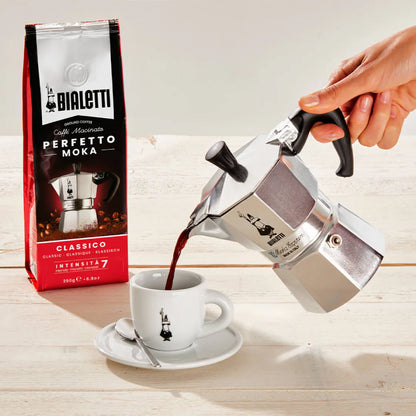 Bialetti Moka Express stovetop coffee maker with black handle and shiny aluminum body for brewing espresso-style coffee