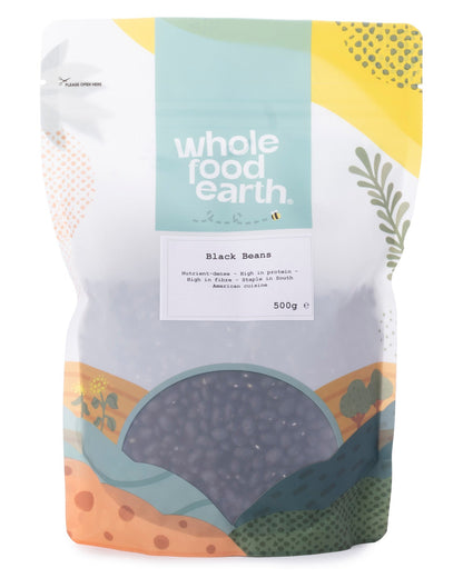 Whole Food Earth black beans in a 500g package, showing shiny black beans in a clear bag for beans and pulses.