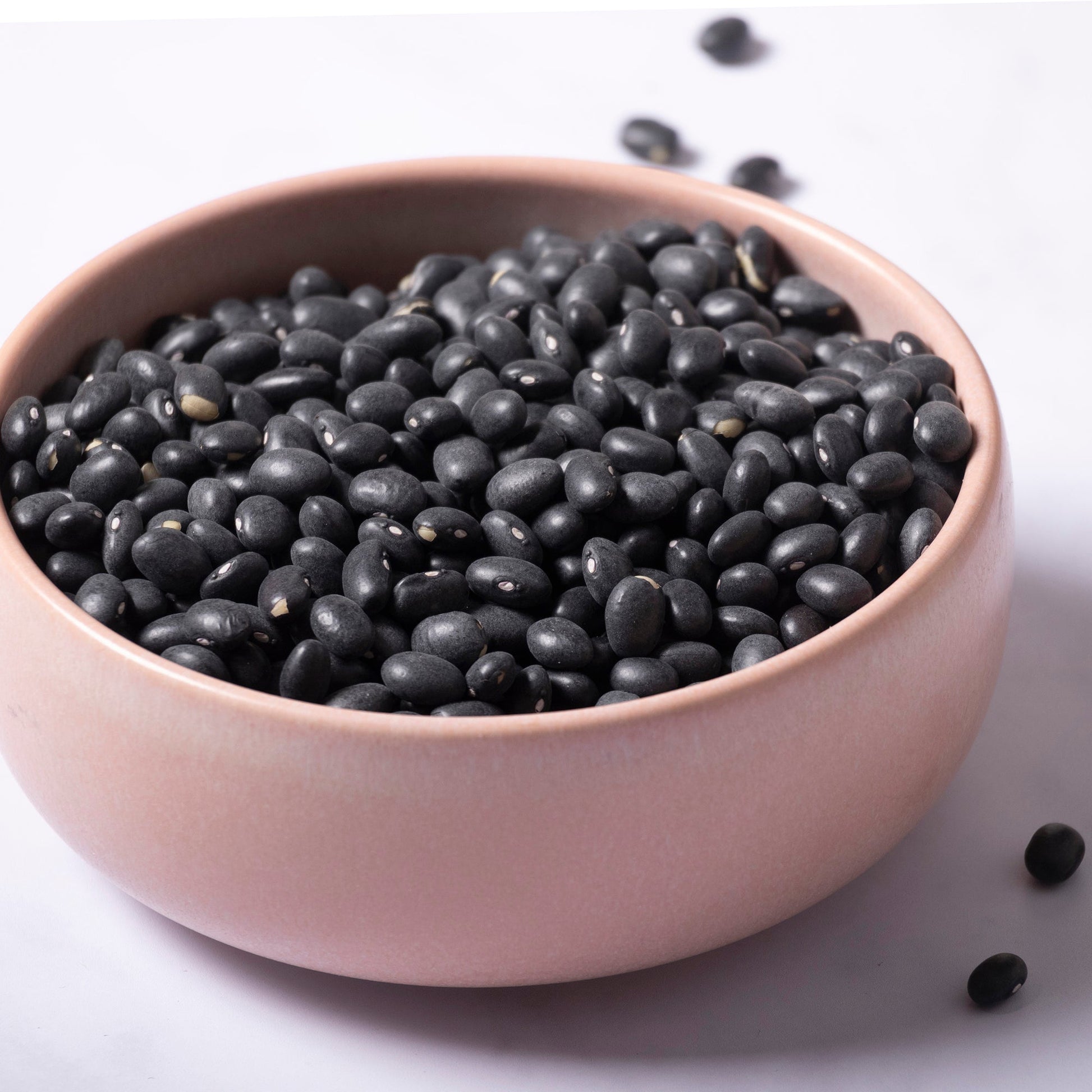 Whole Food Earth black beans in a bowl, showcasing their shiny, black appearance as a nutritious beans and pulses ingredient.