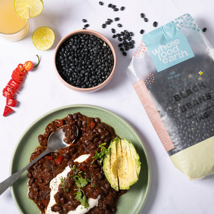 Whole Food Earth black beans in a bowl, showcasing fresh, cooked beans with a rustic kitchen background.