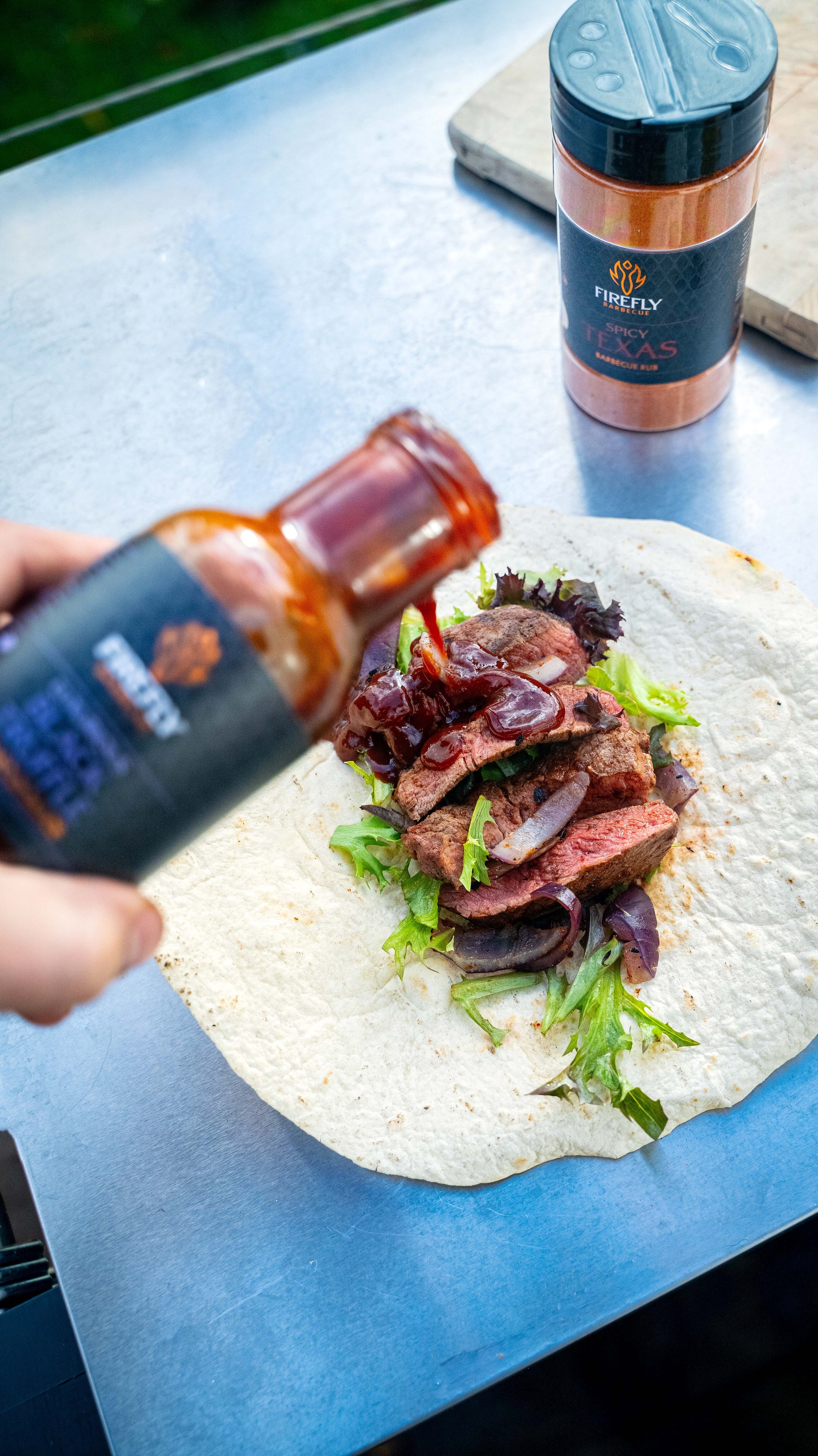FireFly Barbecue black truffle BBQ sauce bottle with rich, dark sauce and elegant label, ideal for enhancing grilled steaks.