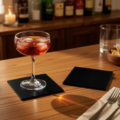 Black glass square coaster from Glassware UK, featuring a sleek design, perfect for protecting surfaces in a stylish setting.