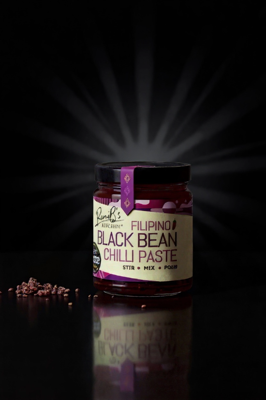 RoniBs Kitchen Filipino Black Bean Chilli Paste hot sauce with dark background, showcasing rich, dark paste and spicy ingredients.
