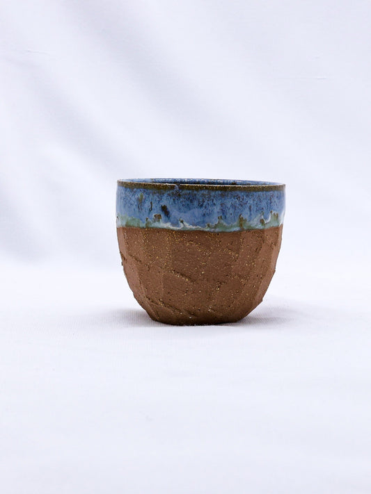 Handmade ceramic Blulume Scultura Terra Stoneware mug by Ribera Handmade Ceramics, showing its textured, earthy design.