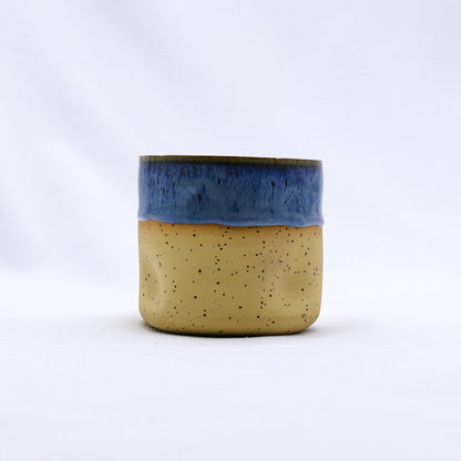 Handmade ceramic Goccia stoneware cup by Ribera Handmade Ceramics, featuring a glazed blue and white design with a smooth, rounded shape.