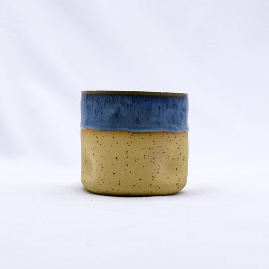 Handmade ceramic Goccia stoneware cup by Ribera Handmade Ceramics, featuring a glazed blue and white design with a smooth, rounded shape.