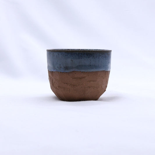 Handmade ceramic terra stoneware mug with a sculptural blue glaze by Ribera Handmade Ceramics.