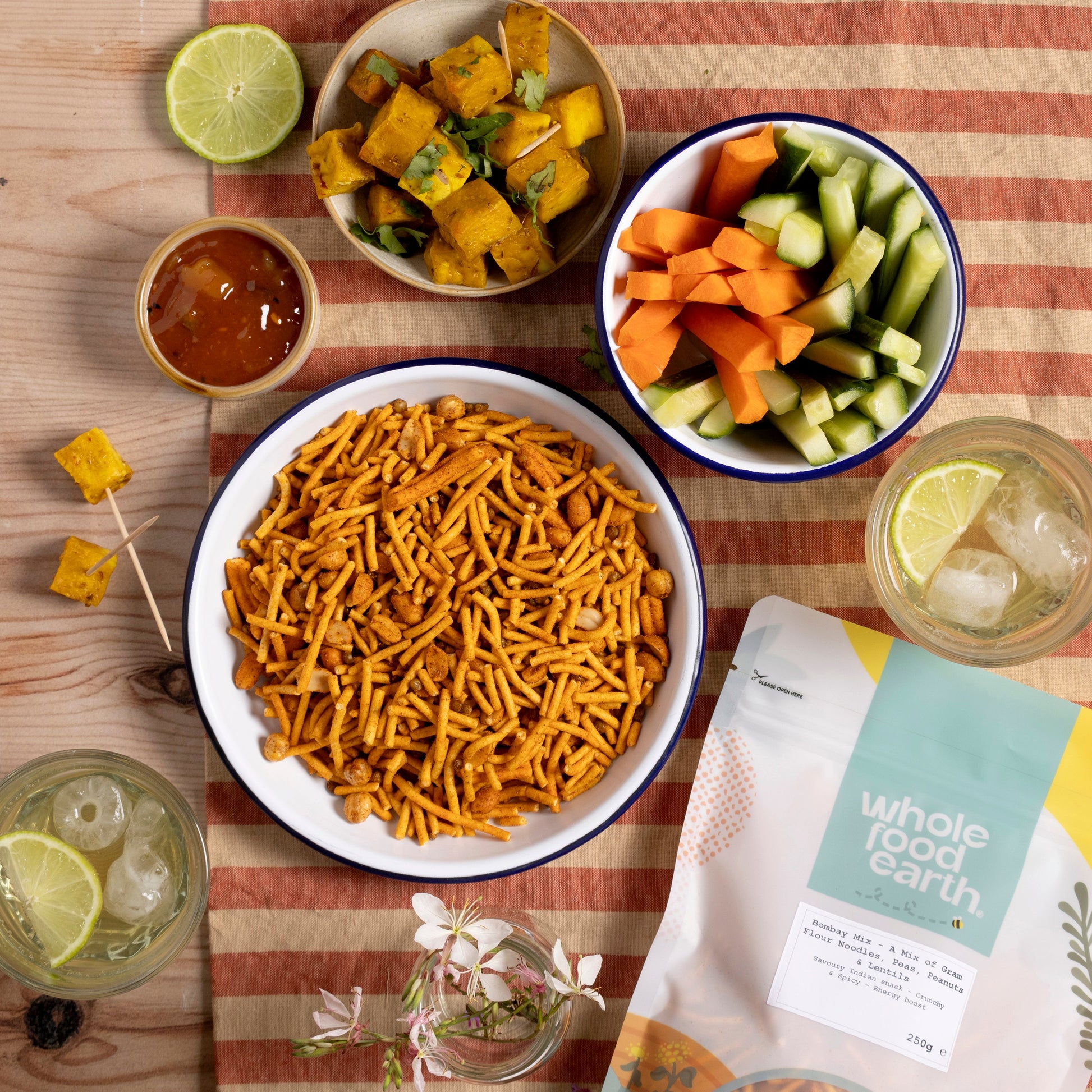 Whole Food Earth Bombay Mix featuring gram flour noodles, peas, peanuts, and lentils in a colorful snack bowl.