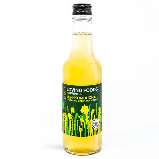 Green tea-flavored organic Jun kombucha in Loving Foods glass bottle with a white label and green accents.