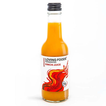 Bottle of Loving Foods organic kimchi juice, a fermented vegetable drink with vibrant labels and clear glass packaging.