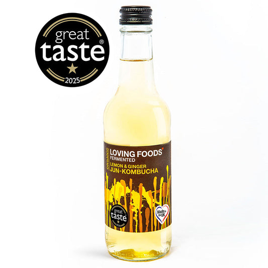 Organic Loving Foods Jun-Kombucha bottle with lemon and ginger flavor, showcasing a clear glass bottle with a lemon slice and ginger roots.