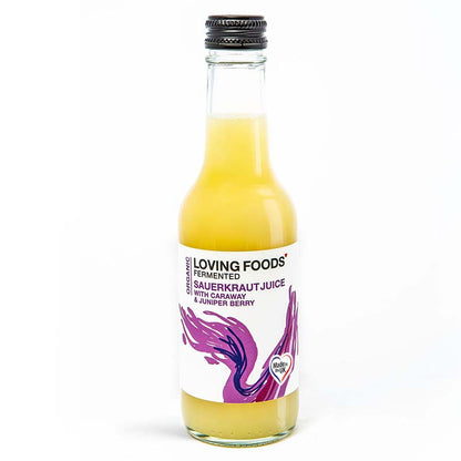 Bottle of Loving Foods organic fermented vegetable juice with caraway and juniper berries, showcasing the clear, amber-colored sauerkraut juice.