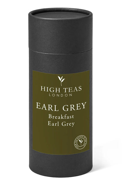 A cup of Breakfast Earl Grey tea from High Teas with a teapot and fresh lemon slices on a white table.