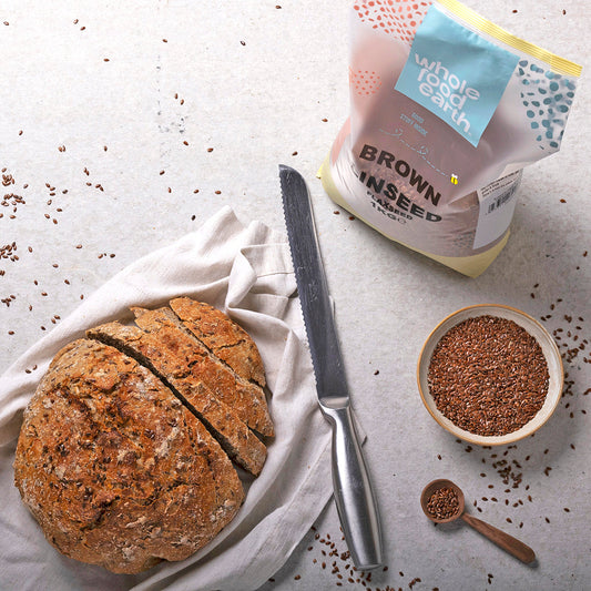Whole Food Earth brown linseed and flaxseed in a bowl, showcasing fresh, whole nuts and seeds for healthy eating.