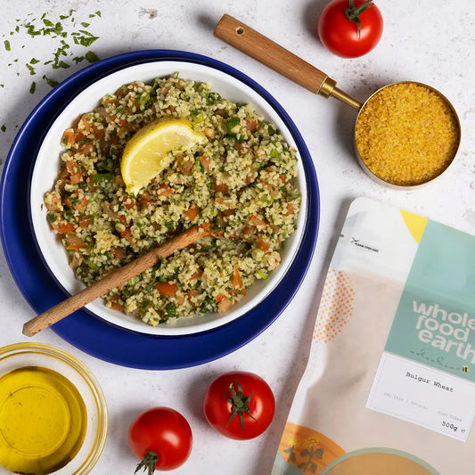 Whole Food Earth bulgur wheat in a bowl with cooking ingredients, showcasing natural, healthy grains for nutritious meals.