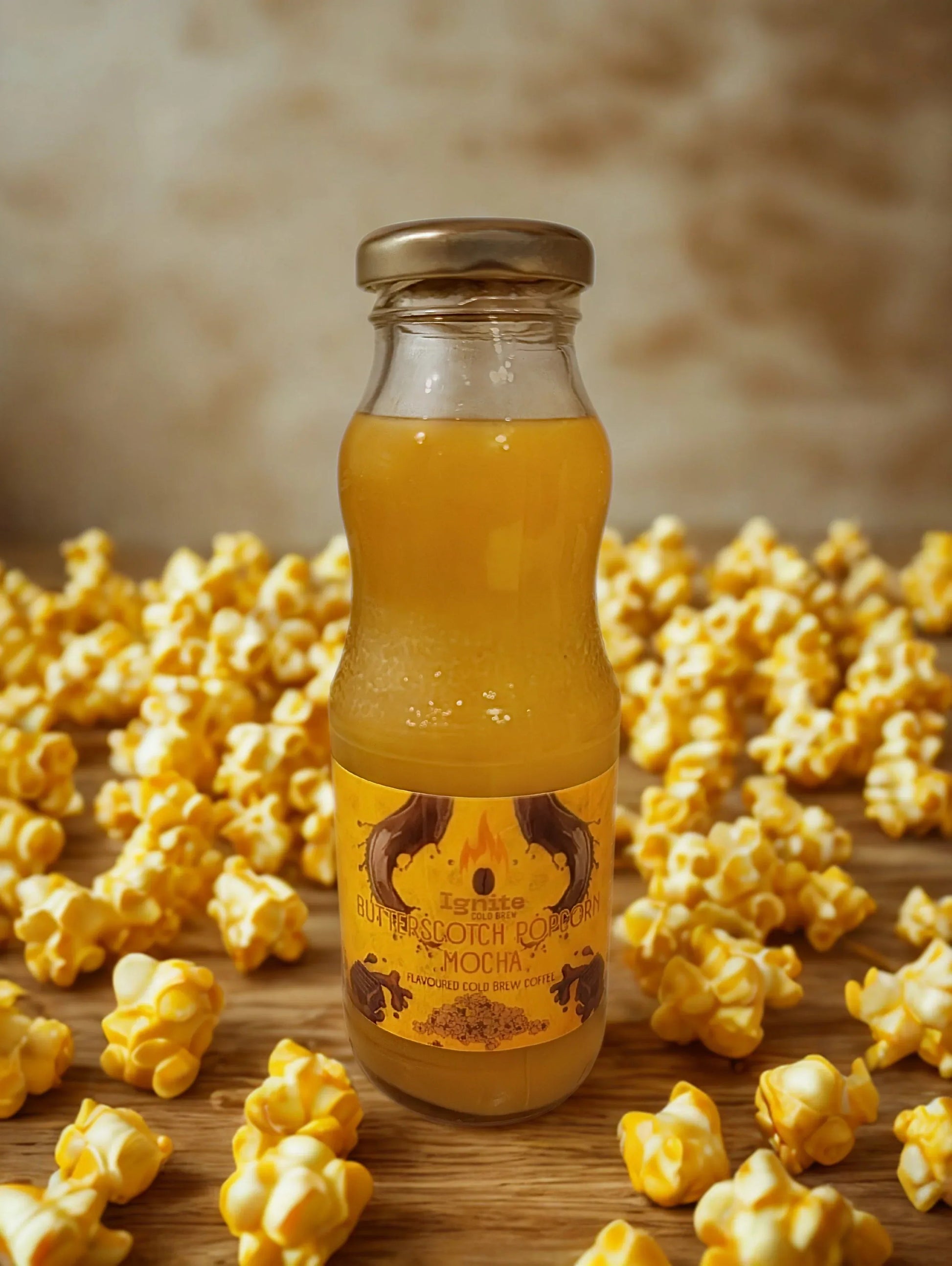 Ignite Coffee Co Popcorn Mocha Pack showing six cold brew bottles with butterscotch popcorn twist flavor, velvety chocolate mocha taste