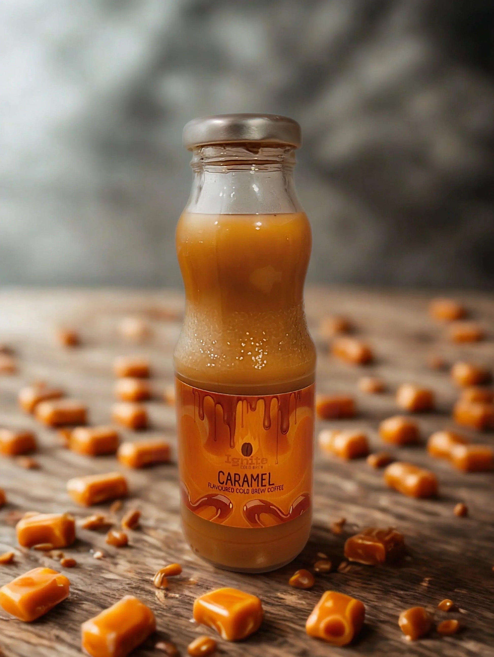 Six bottles of Ignite Coffee Co. Core Flavours Pack featuring signature caramel cold brew bottles on a rustic wooden table.